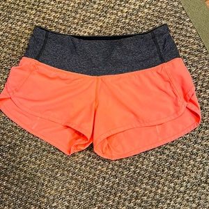 Lululemon shorts; orange and gray; 2.5” inseam; size 2. Very good condition.